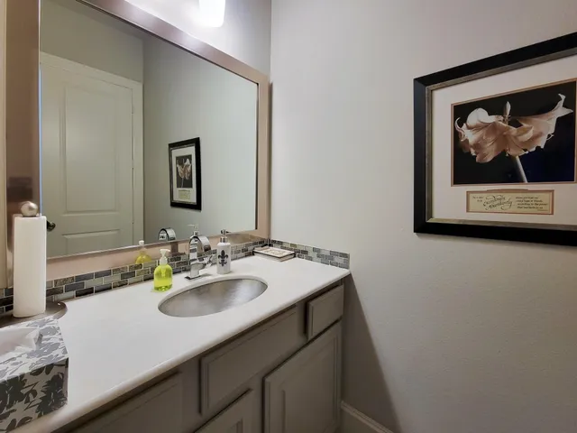a bathroom with a sink mirror and vanity