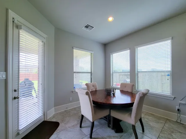a view of a dining room with furniture and window