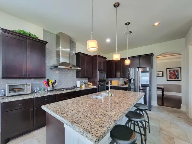 a kitchen that has a table and chairs in it