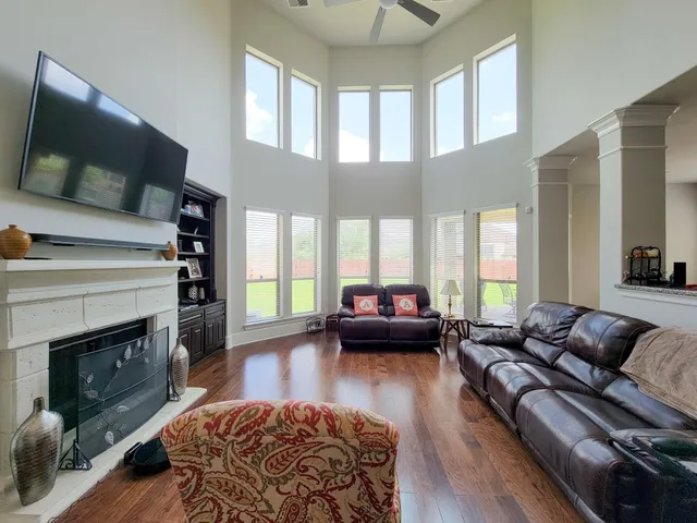 a living room with furniture fireplace and flat screen tv