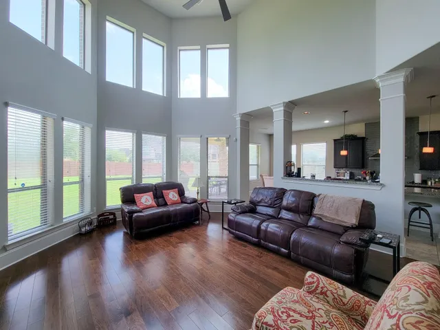 a living room with furniture and a large window