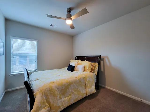 a bedroom with a bed and a chandelier