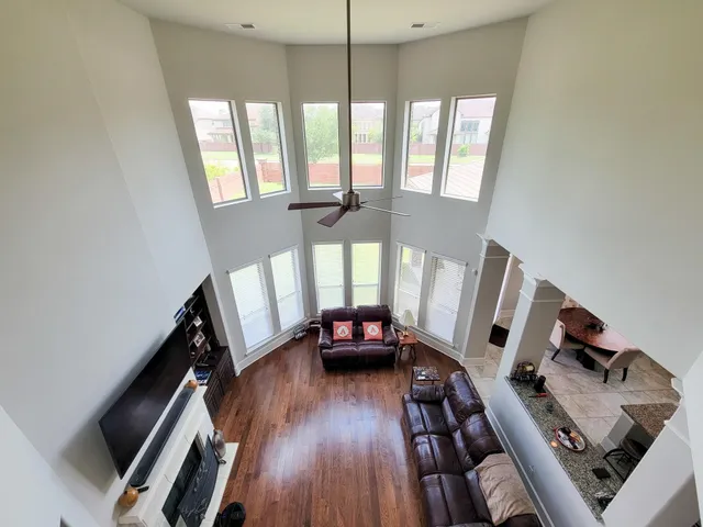 a living room with furniture and a wooden floor