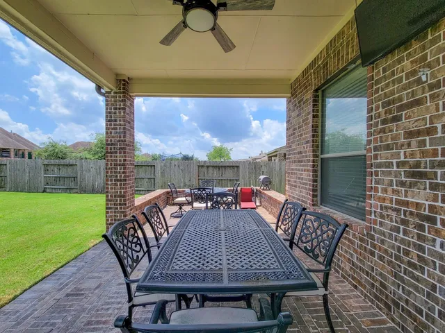 a view of an outside dining space with furniture