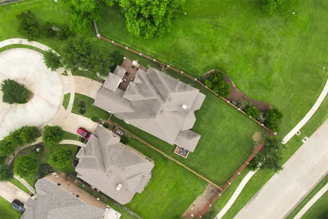 an aerial view of a house with a yard and lake view