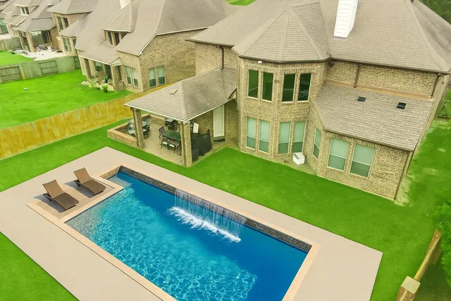 an aerial view of a house with a big yard