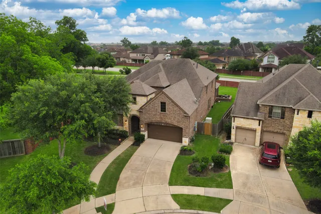 an aerial view of a house with a yard