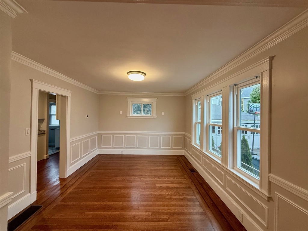 224 Faneuil Street, Unit 1 Boston, MA 02135 - Photo 5 of 19 a view of empty room with wooden floor and fan