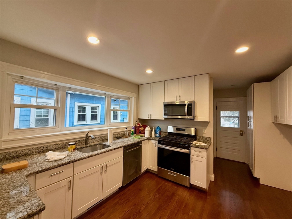 224 Faneuil Street, Unit 1 Boston, MA 02135 - Photo 7 of 19 a kitchen with stainless steel appliances granite countertop a stove and a sink