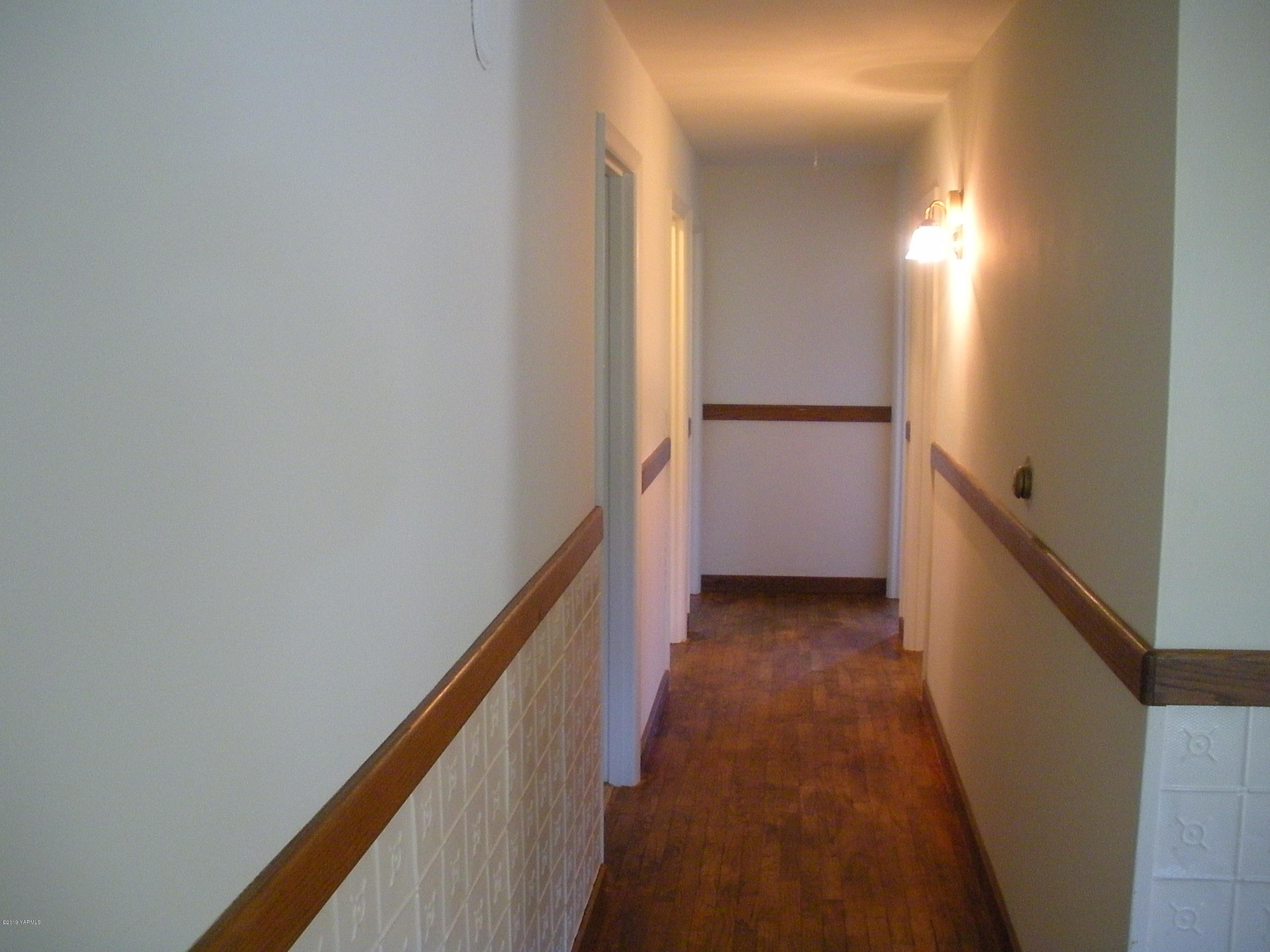 1151 Cook Road Yakima, WA 98908 - Photo 8 of 26 a view of a hallway with wooden floor
