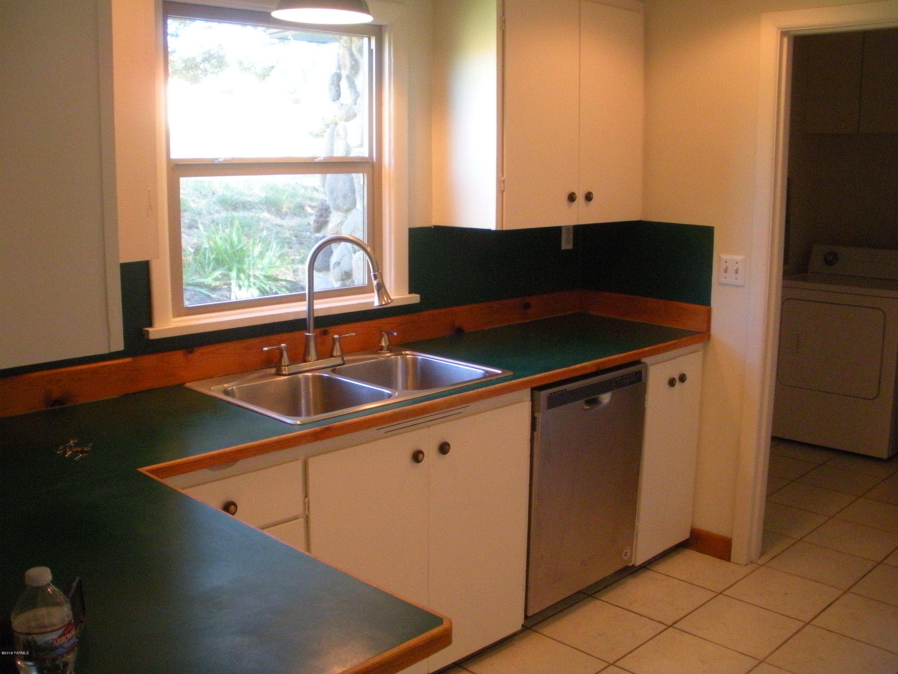 1151 Cook Road Yakima, WA 98908 - Photo 10 of 26 a kitchen with a sink and a window