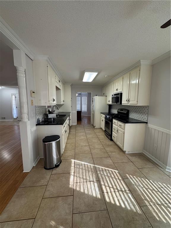 1136 Fieldstone Drive Canton, GA 30114 - Photo 5 of 10 a kitchen with stainless steel appliances a sink a stove a refrigerator cabinets and a window