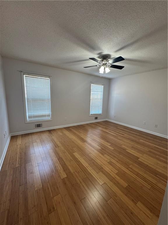 1136 Fieldstone Drive Canton, GA 30114 - Photo 8 of 10 wooden floor in an empty room with a window