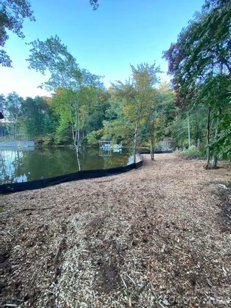 a view of a dirt road with a building in the background