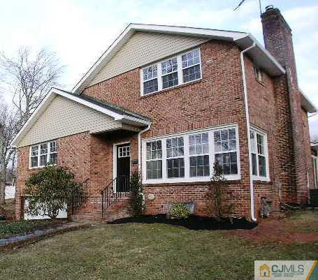 305 Chain O' Hills Road Colonia, NJ 07067 - Photo 1 of 20 front view of a house with a yard