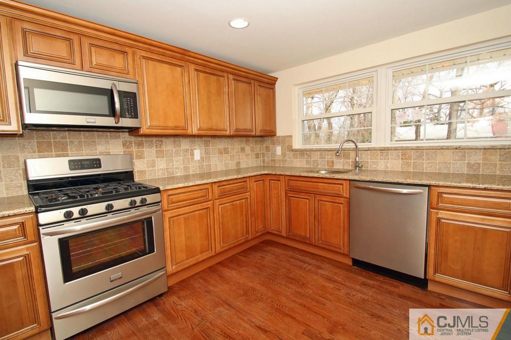 305 Chain O' Hills Road Colonia, NJ 07067 - Photo 2 of 20 a kitchen with stainless steel appliances a stove a sink and a microwave