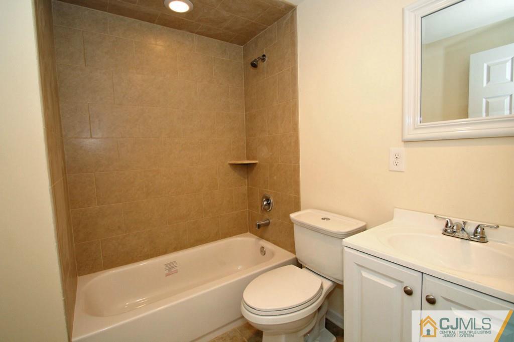 305 Chain O' Hills Road Colonia, NJ 07067 - Photo 11 of 20 a white toilet sitting next to a bath tub