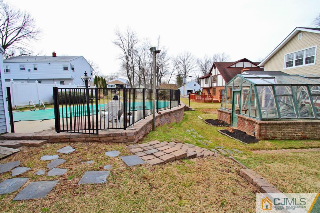 305 Chain O' Hills Road Colonia, NJ 07067 - Photo 19 of 20 a view of a house with wooden fence