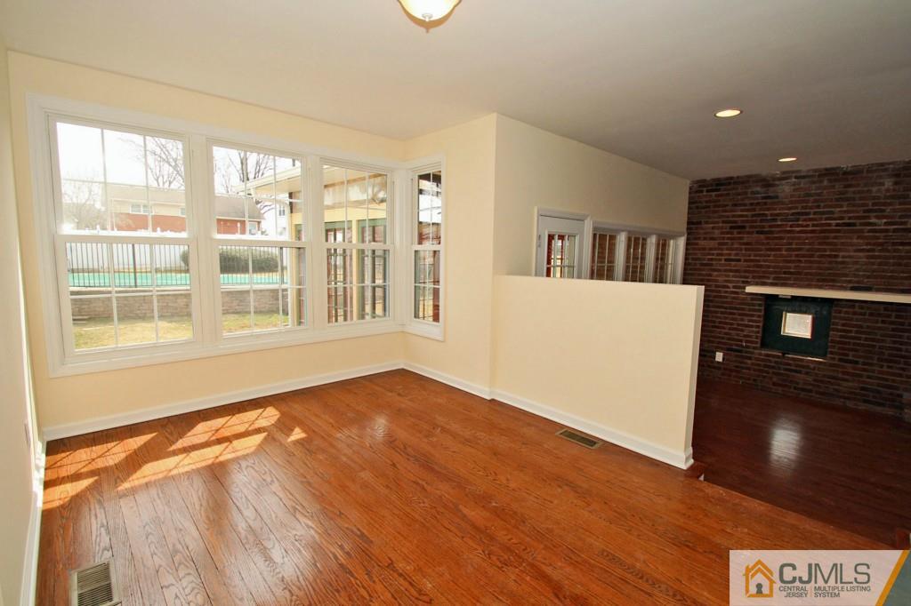 305 Chain O' Hills Road Colonia, NJ 07067 - Photo 4 of 20 a view of an empty room with wooden floor and a window
