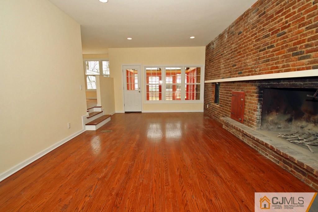 305 Chain O' Hills Road Colonia, NJ 07067 - Photo 5 of 20 a view of an empty room with wooden floor and a window