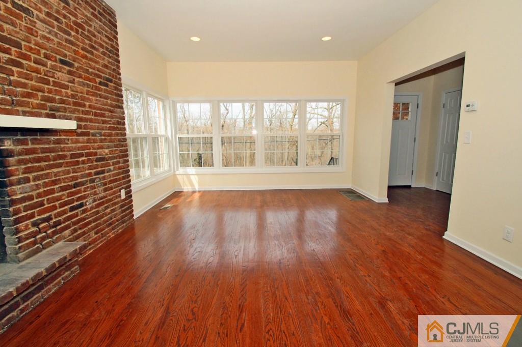 305 Chain O' Hills Road Colonia, NJ 07067 - Photo 6 of 20 a view of an empty room with wooden floor and a window