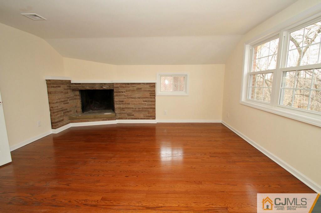 305 Chain O' Hills Road Colonia, NJ 07067 - Photo 7 of 20 an empty room with wooden floor and windows