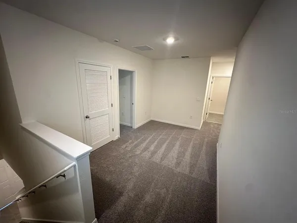 an empty room with an entryway door