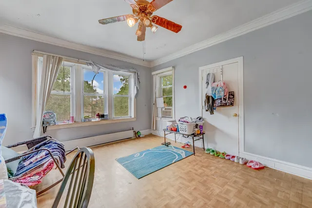 a bedroom with furniture and a large window