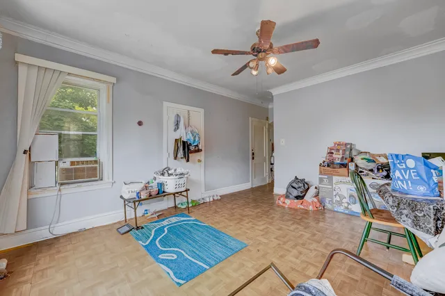 a room with furniture and view of bedroom