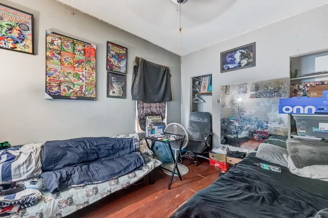 a living room with furniture a flat screen tv and a wall paintings