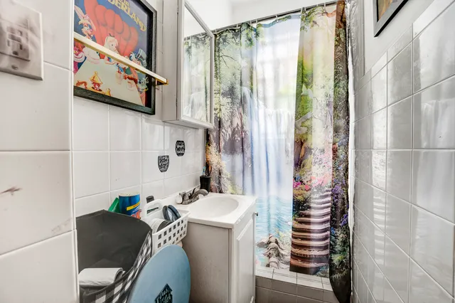 a bathroom with a bathtub and shower