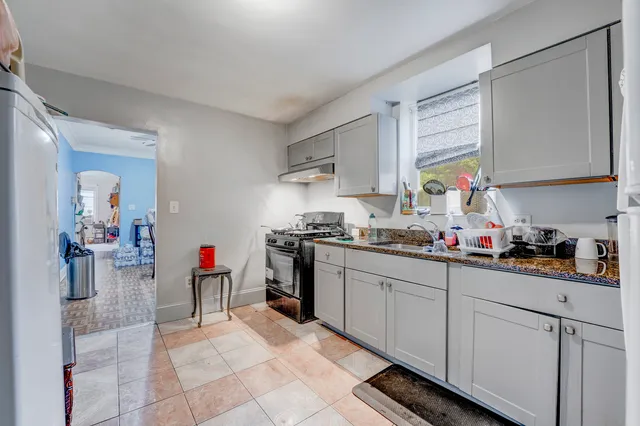 a kitchen that has a sink and a stove in it