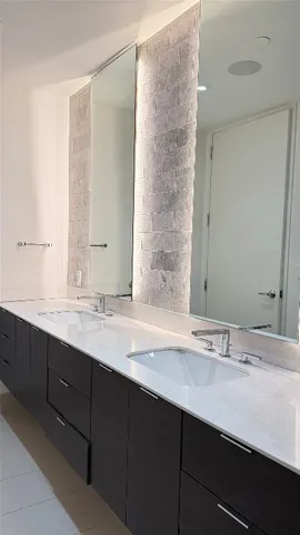 a bathroom with a double vanity sink and a mirror