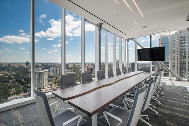 a dining room with furniture water view and a flat screen tv