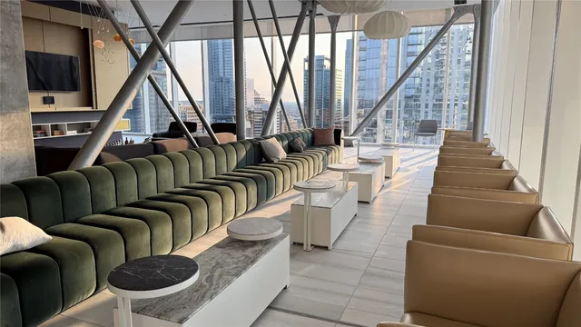 a living room with furniture and a floor to ceiling window