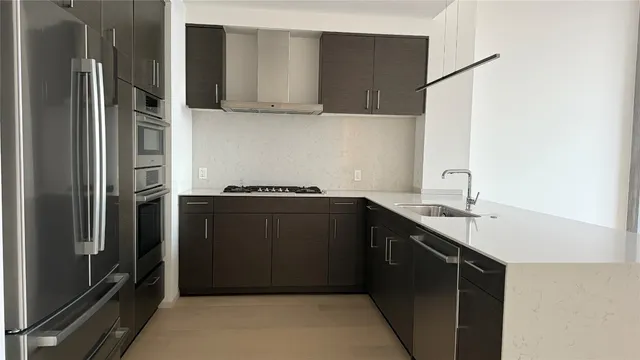 a kitchen with a sink and a refrigerator