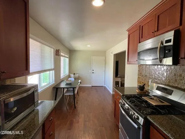 a kitchen with a stove and a microwave