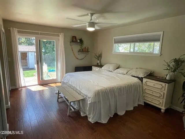 a bedroom with bed and wooden floor