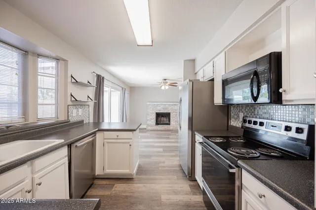 a kitchen with a stove a sink and a microwave