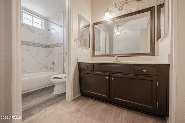 a bathroom with a sink a toilet and bathtub