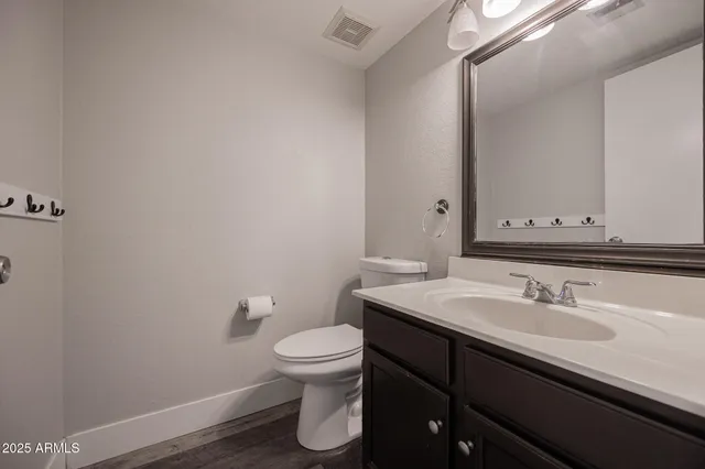 a bathroom with a sink toilet and vanity
