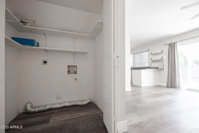 a view of a kitchen with refrigerator and white cabinets