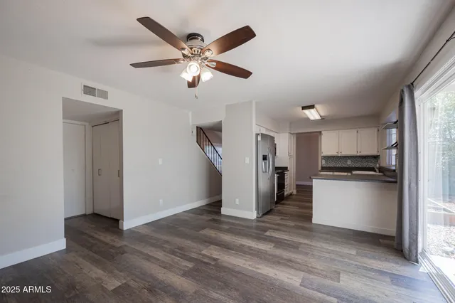 a kitchen with stainless steel appliances granite countertop a refrigerator and a stove top oven