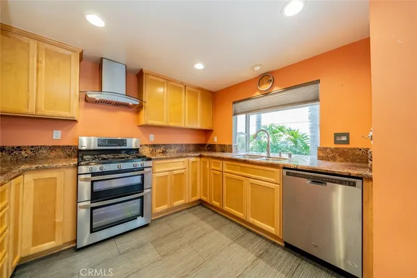 a kitchen with stainless steel appliances granite countertop a stove and a refrigerator
