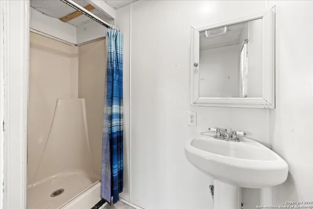 a bathroom with a sink and a mirror