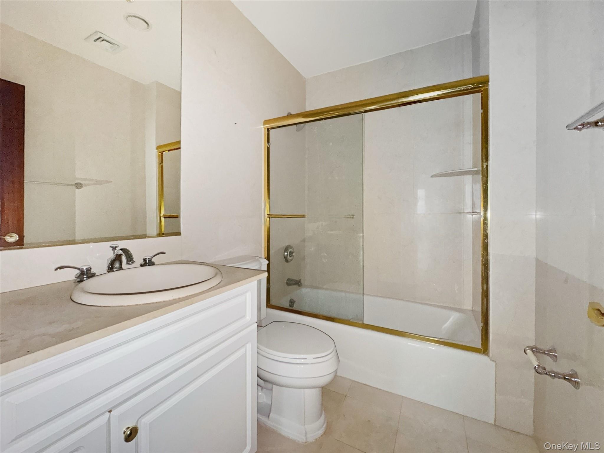 171 Great Neck Road, Unit 1C Great Neck, NY 11021 - Photo 12 of 17 a bathroom with a sink a toilet and shower