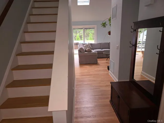 a large bed sitting in a bedroom next to a window