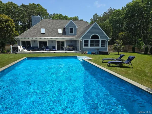 a front view of house with yard and swimming pool