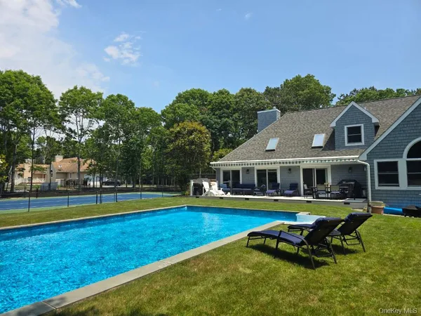 a view of a house with swimming pool and porch