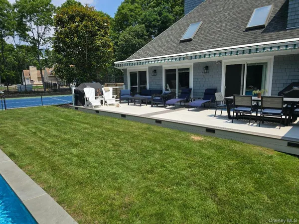 a view of a house with backyard porch and sitting area